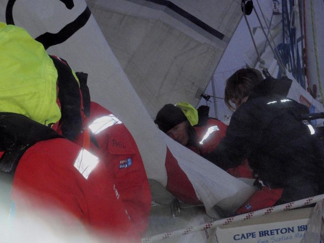 David Raeburn & Katherine Simpson repair the mainsail © Clipper Ventures PLC . http://www.clipperroundtheworld.com